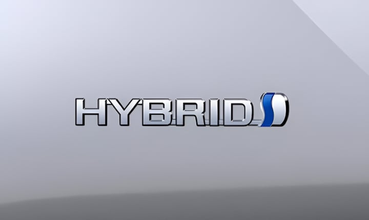 A close up of the Toyota Hybrid badge on a silver Prius.